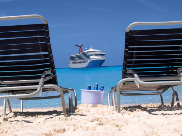 Beach chairs and cruise ship in the middle far away